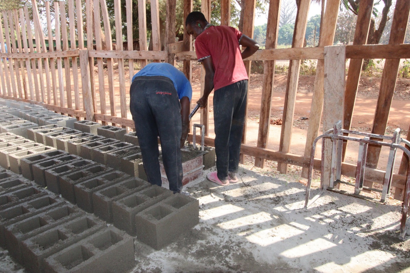 Two young men producing ventilator bricks in Yambio